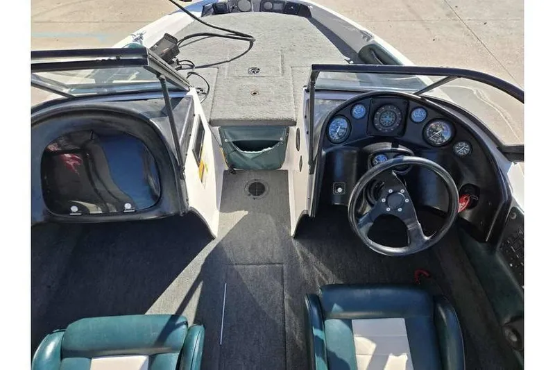 Slide: The Image of 1997 Javelin 389 FS boat interior with steering wheel and dashboard gauges. - 12