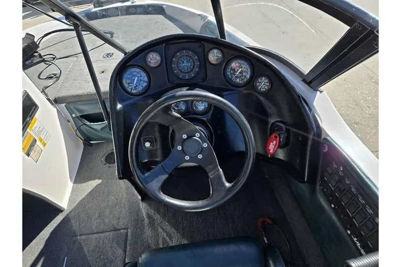 Slide: The Image of 1997 Javelin 389 FS boat dashboard with steering wheel and instrument panel. - 13