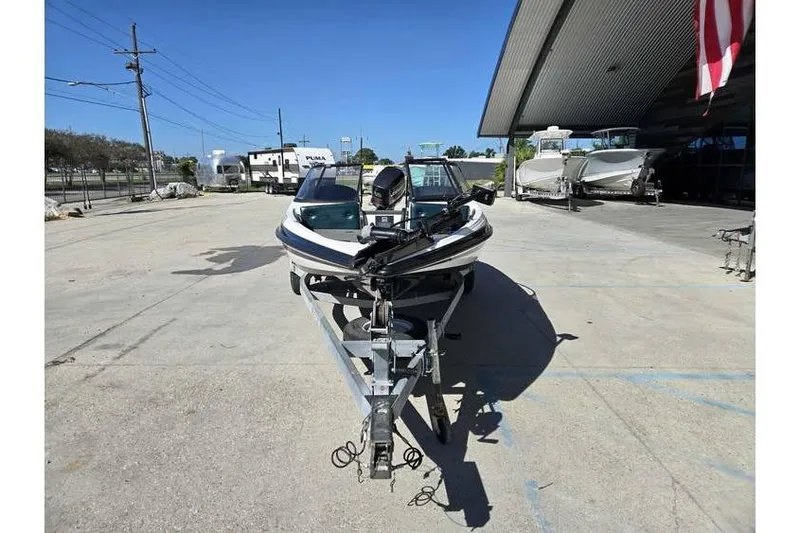 Slide: The Image of 1997 Javelin 389 FS boat on trailer in outdoor storage area. - 3