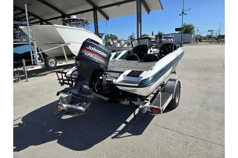 Slide: The Image of 1997 Javelin 389 FS boat with Johnson 175 Fast Strike outboard motor on trailer. - 8