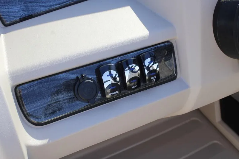 Slide: The Image of Control panel of 2026 Avalon LSZ Cruise Rear Bench boat with switches and power outlet. - 21