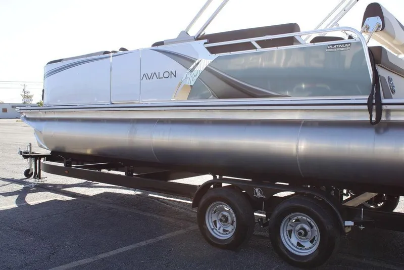 Slide: The Image of 2026 Avalon LSZ Cruise Rear Bench pontoon boat on trailer, side view. - 34