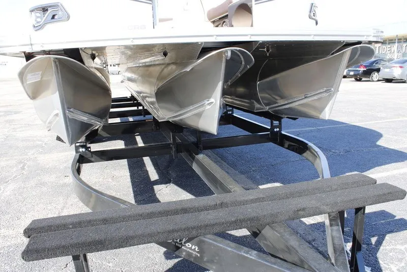 Slide: The Image of 2026 Avalon LSZ Cruise Rear Bench pontoon boat on trailer, showcasing triple hull design. - 4