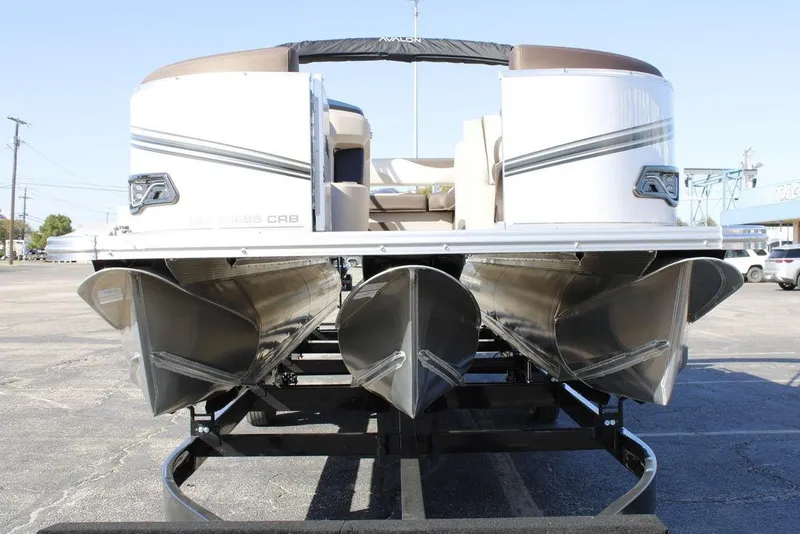 Slide: The Image of 2026 Avalon LSZ Cruise Rear Bench pontoon boat, 26-foot, on trailer, front view. - 7