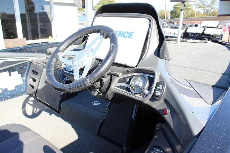 Slide: The Image of 2016 Skeeter FX21 Limited Edition boat dashboard with steering wheel and controls. - 11