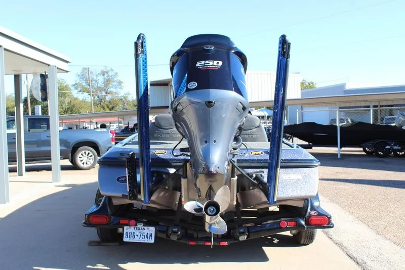 Slide: The Image of 2016 Skeeter FX21 Limited Edition boat with powerful outboard motor, parked on trailer. - 2