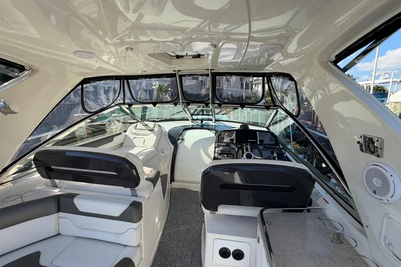 Slide: The Image of Interior of a 2012 Monterey 400 Sport Yacht, featuring sleek seating and modern controls. - 17