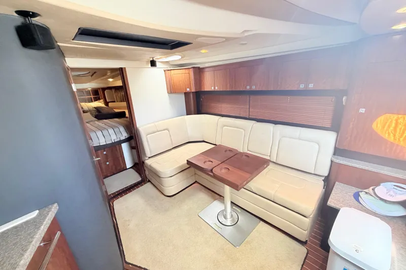 Slide: The Image of Interior of 2012 Monterey 400 Sport Yacht with beige seating and wooden accents. - 25