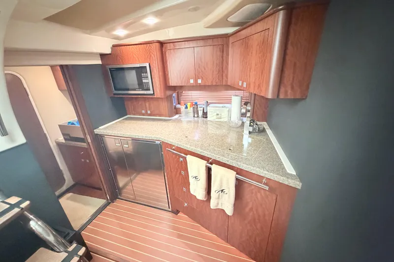 Slide: The Image of Luxurious kitchen interior of 2012 Monterey 400 Sport Yacht with wood cabinetry and modern appliances. - 27