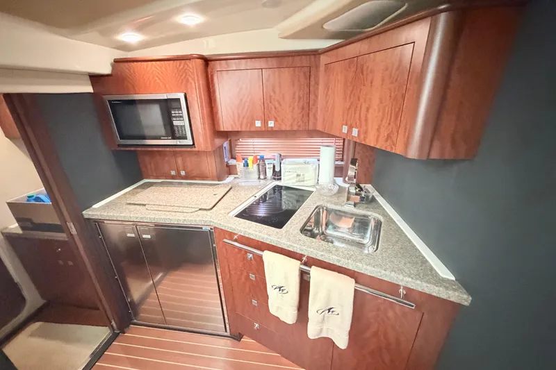 Slide: The Image of Luxurious kitchen in 2012 Monterey 400 Sport Yacht with wood cabinets and modern appliances. - 28