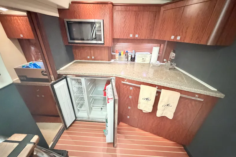 Slide: The Image of Luxurious kitchen interior of 2012 Monterey 400 Sport Yacht with wood cabinetry and modern appliances. - 29