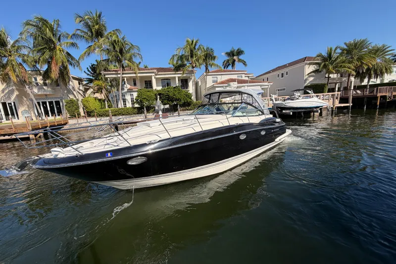 Slide: The Image of 2012 Monterey 400 Sport Yacht cruising near waterfront homes and palm trees. - 3