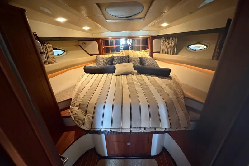 Slide: The Image of Luxurious interior of a 2012 Monterey 400 Sport Yacht with cozy bedding and elegant lighting. - 30