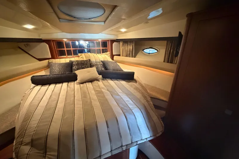 Slide: The Image of Luxurious cabin interior of a 2012 Monterey 400 Sport Yacht with cozy bedding. - 31