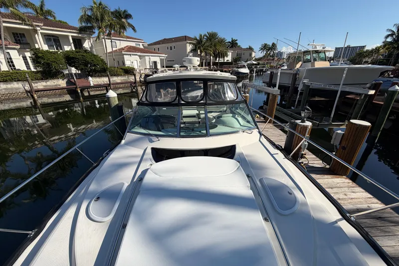 Slide: The Image of 2012 Monterey 400 Sport Yacht docked in a sunny marina setting. - 41