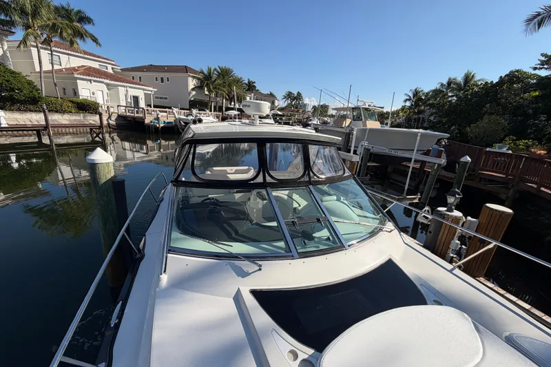 Slide: The Image of 2012 Monterey 400 Sport Yacht docked in a sunny marina setting. - 42