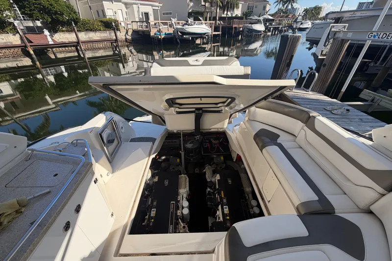 Slide: The Image of 2012 Monterey 400 Sport Yacht engine compartment open at dockside. - 43