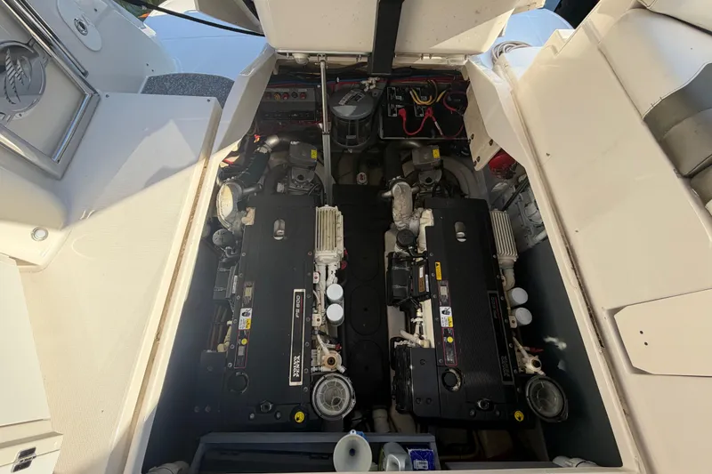 Slide: The Image of Engine compartment of a 2012 Monterey 400 Sport Yacht, showcasing dual engines and components. - 44