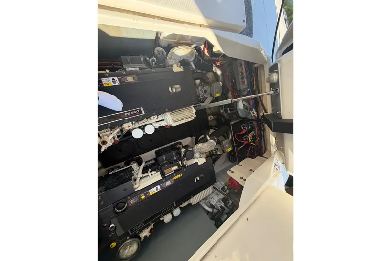 Slide: The Image of Engine compartment of a 2012 Monterey 400 Sport Yacht, showcasing mechanical components and wiring. - 45