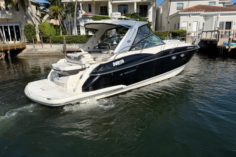 Slide: The Image of 2012 Monterey 400 Sport Yacht cruising near waterfront homes. - 5