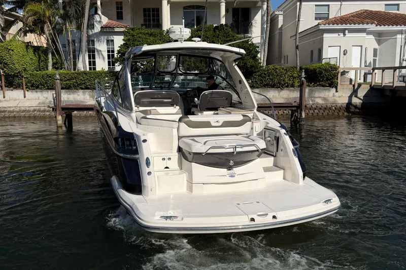 Slide: The Image of 2012 Monterey 400 Sport Yacht docked near waterfront homes. - 6