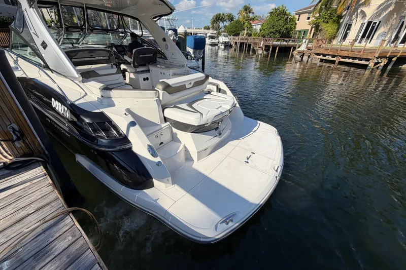 Slide: The Image of 2012 Monterey 400 Sport Yacht docked in a scenic waterfront setting. - 8