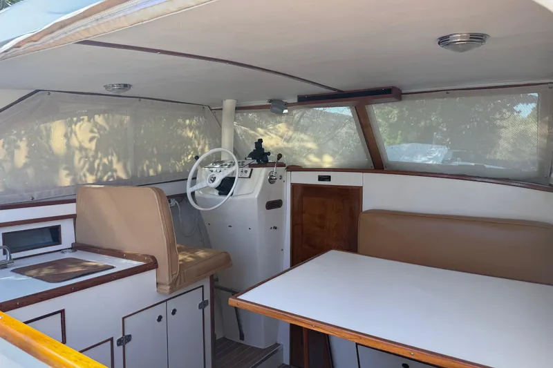 Slide: The Image of 1969 Custom Alglas Saint John 25 ft. Sportfisher interior with helm, seating, and kitchenette. - 11