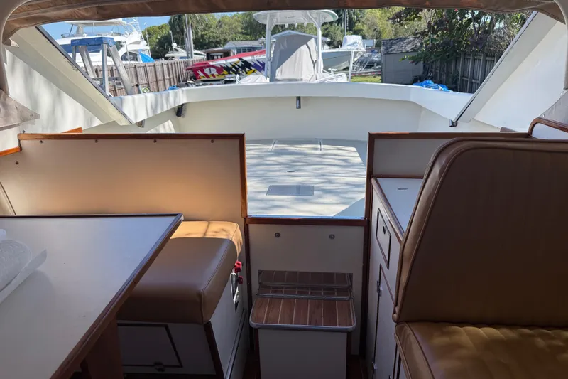 Slide: The Image of Interior of a 1969 Custom Alglas Saint John 25 ft. Sportfisher boat, featuring seating and cabinetry. - 15