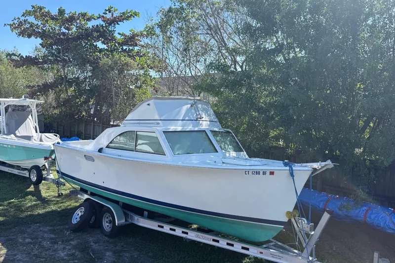 Slide: The Image of 1969 Custom Alglas Saint John 25 ft. Sportfisher on trailer, surrounded by trees. - 2