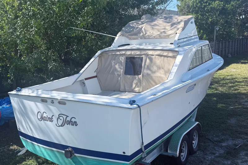 Slide: The Image of 1969 Custom Alglas Saint John 25 ft. Sportfisher on trailer, surrounded by trees. - 3