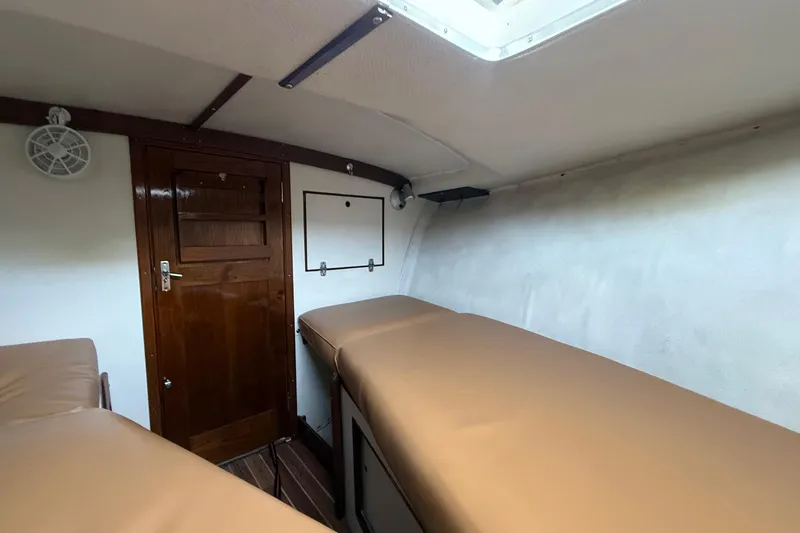 Slide: The Image of Interior cabin of 1969 Alglas Saint John 25 ft. Sportfisher with wooden door and beige seating. - 9