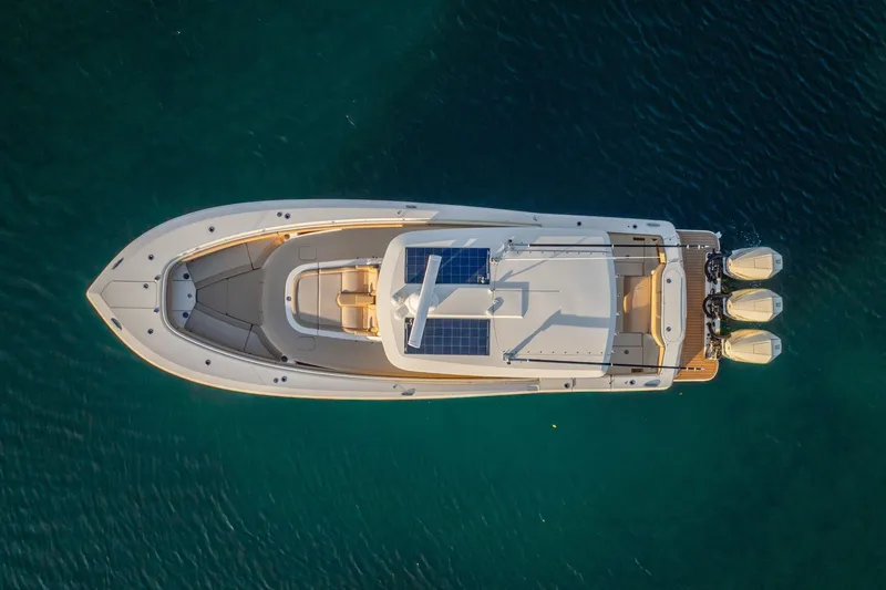 Slide: The Image of Top view of 2020 Scout 355 LXF boat with solar panels and triple engines. - 16