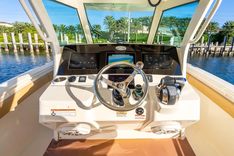 Slide: The Image of 2020 Scout 355 LXF boat helm with modern controls and navigation system. - 17