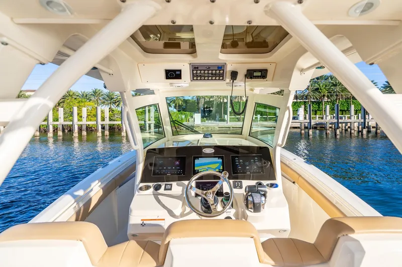 Slide: The Image of 2020 Scout 355 LXF boat cockpit with advanced navigation system and luxurious seating. - 18
