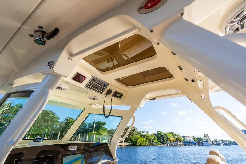 Slide: The Image of 2020 Scout 355 LXF boat interior with control panel and scenic water view. - 22