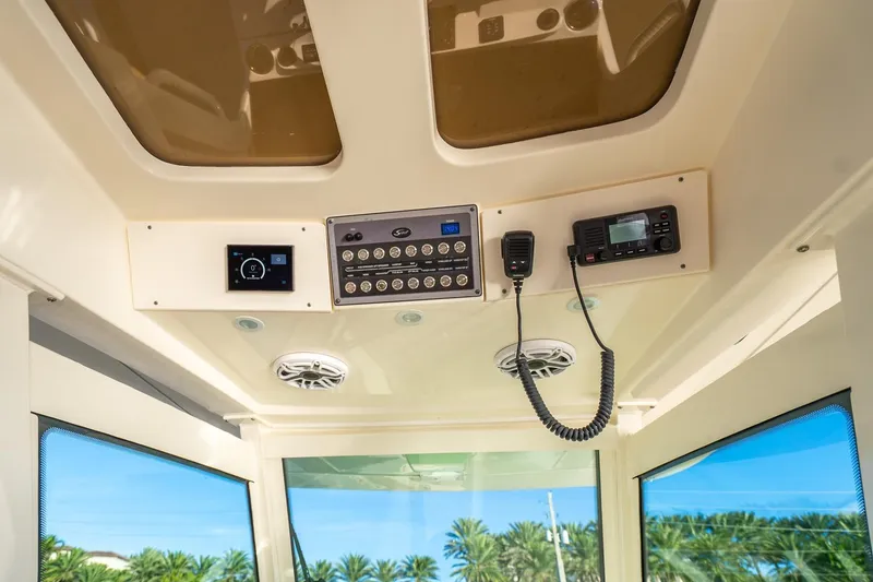 Slide: The Image of 2020 Scout 355 LXF boat interior dashboard with control panel and radio. - 23
