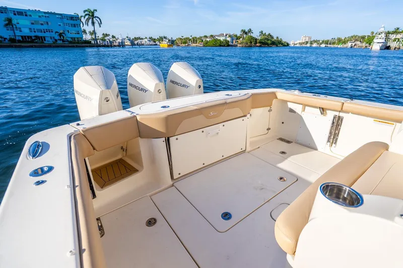 Slide: The Image of 2020 Scout 355 LXF boat with Mercury engines on a sunny waterfront. - 26