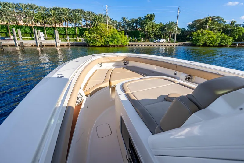 Slide: The Image of 2020 Scout 355 LXF boat interior with luxurious seating and waterfront view. - 29