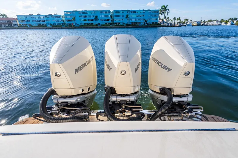 Slide: The Image of 2020 Scout 355 LXF boat with triple Mercury outboard engines on water. - 36