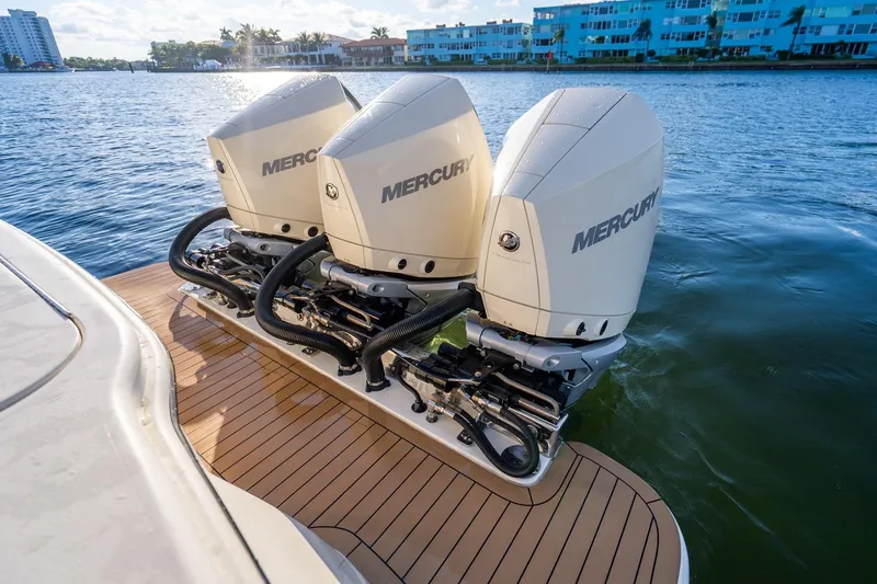 Slide: The Image of 2020 Scout 355 LXF boat with triple Mercury outboard engines on water. - 37
