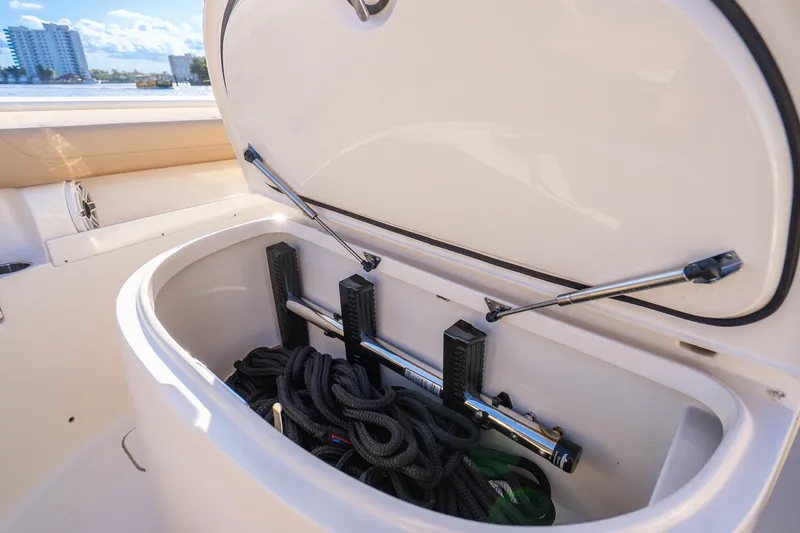 Slide: The Image of 2020 Scout 355 LXF boat storage compartment with ropes and equipment. - 42