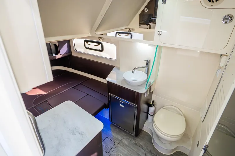 Slide: The Image of 2020 Scout 355 LXF cabin interior with bed, sink, and toilet. - 44