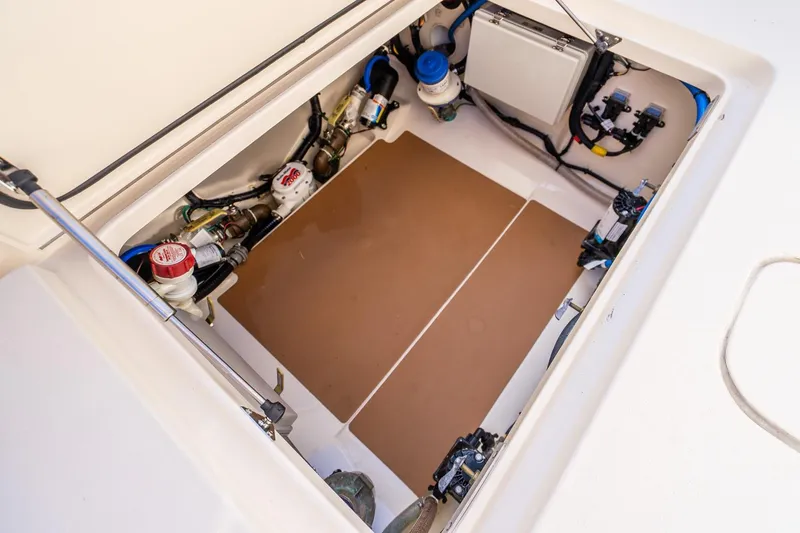 Slide: The Image of 2020 Scout 355 LXF boat compartment with mechanical components and wiring. - 48