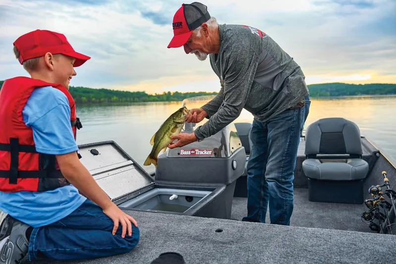 Slide: The Image of Father and son fishing on a 2025 Bass Tracker Classic XL boat at sunset. - 14