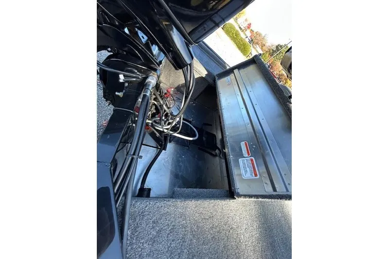 Slide: The Image of 2025 Bass Tracker Classic XL boat interior with open storage compartment and visible wiring. - 5