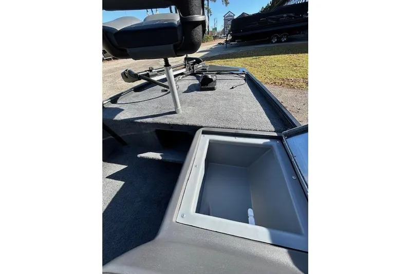 Slide: The Image of 2025 Bass Tracker Classic XL boat interior with open storage compartment and seating. - 6