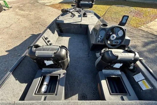 Slide: The Image of 2025 Bass Tracker Classic XL boat interior with dual seats and steering console. - 7