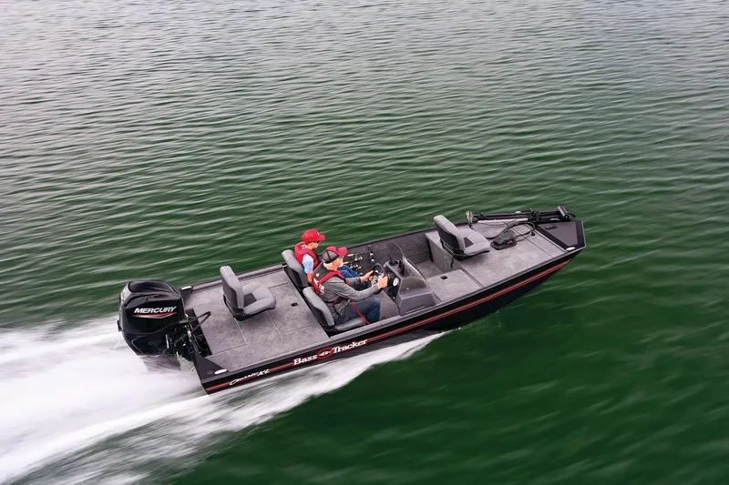 Slide: The Image of 2025 Bass Tracker Classic XL boat cruising on a lake with two passengers. - 9