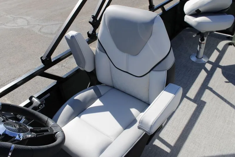 Slide: The Image of 2026 Avalon Venture 85 Rear Fish boat interior with plush seating and steering wheel. - 23