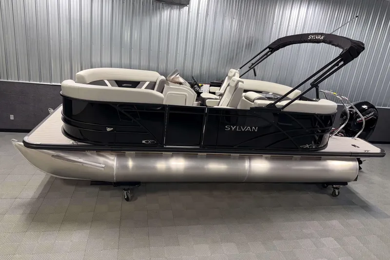 The Image of 2026 Sylvan Mirage X1 pontoon boat in showroom, sleek design, black exterior. - 0